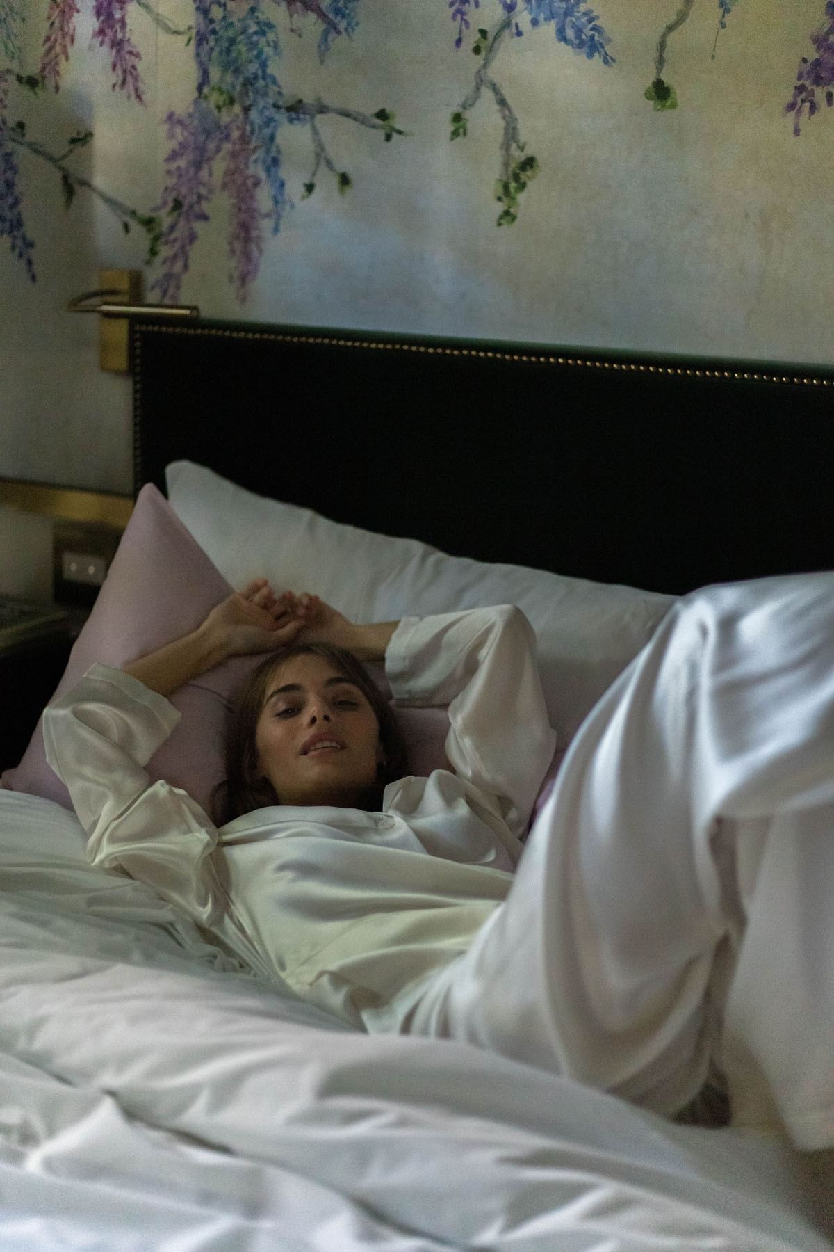 A woman lying on a bed at Brazilian Court